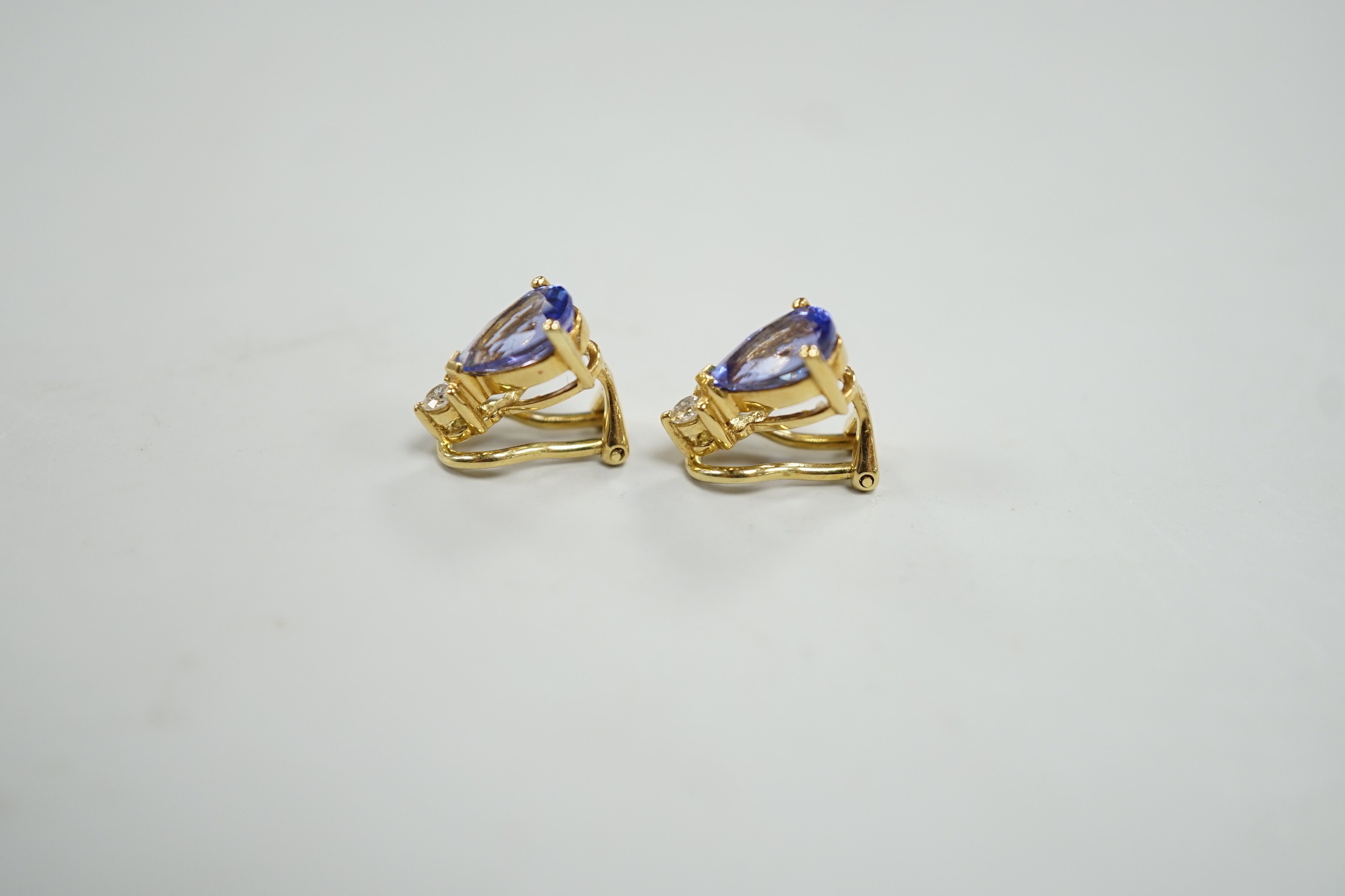 A modern pair of 18k, tanzanite and diamond set ear clips, 13mm, gross weight 4.4 grams.